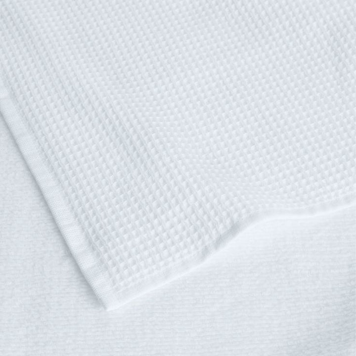 DWR Waffle Towel in White, featuring a textured waffle weave design. This towel offers a sophisticated look with excellent absorbency and a soft, breathable feel, perfect for adding a touch of elegance to your bathroom