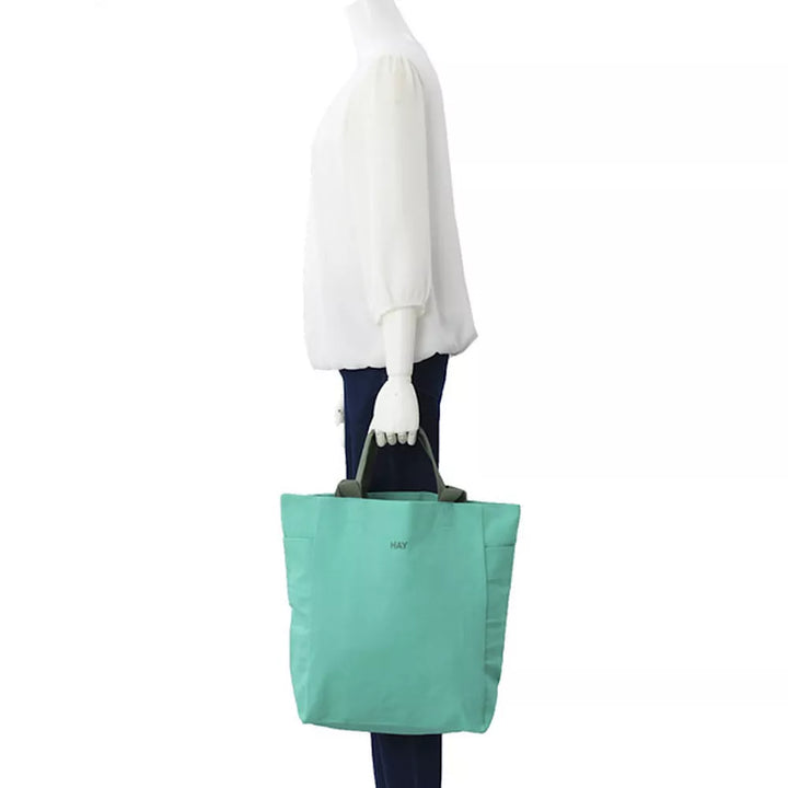 HAY Everyday tote bag. Practical and stylish design with ample space for daily essentials. Features sturdy handles and a versatile look, perfect for carrying items to work, the gym, or running errands.